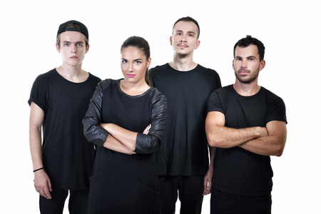 Music band studio portrait. Musicians posing in studio over white background, image toned and noise added.の写真素材
