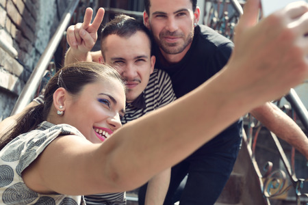 Friends taking self photo with smart phone. Selfie, friendship, young adult, leisure concept.