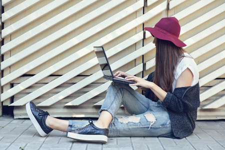 young woman using laptop outddorの写真素材