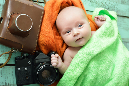 Portrait of cute baby boy with retro photo camerasの写真素材