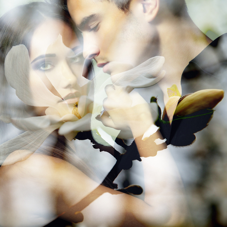 Double exposure portrait of sexy passion couple and blooming spring magnolia branch.の写真素材