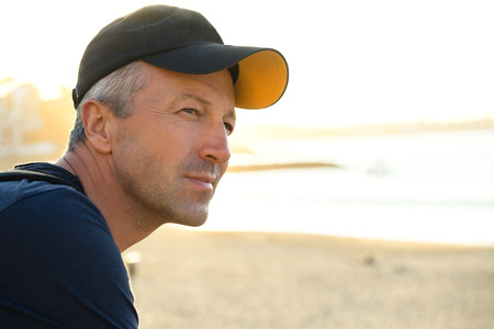 Handsome man. Outdoor male portrait. Middle-aged man resting at the beach, summer outdoor portrait, image toned. Saint Jean de Luz, France.の写真素材