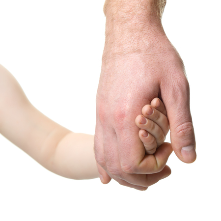 Father leads his child. Trust, family, assistance, parenting, childhood concept. Man's and kid's hands closeaup over white background.の写真素材