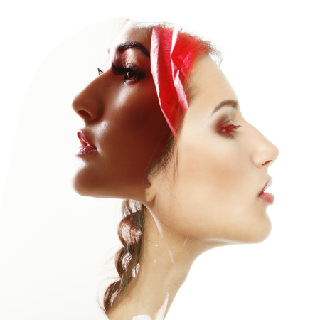 Double exposure portrait of two beautiful fashion girls. Young women in love.の写真素材