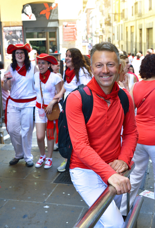 People celebrate San Fermin festival in traditional white abd red clothing with red necktie, 06 July 2016, Pamplona, Navarra, Spain.のeditorial素材