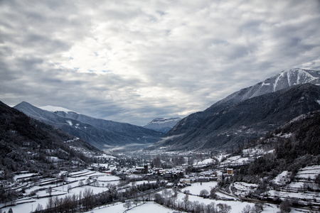 Dark misty landscape with mountains, Broto, Spain, Europe. Winter in Pyrenees.の写真素材