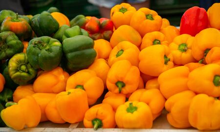 Fresh raw sweet peppers sold on outdoor market. Farm seasonal spanish fruits and vegetables
