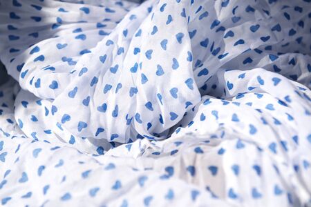 Cloth. White fabric with blue hearts, textile background