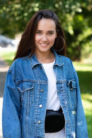 Portrait of beautiful young girl posing in summer park. Majestic woman's beauty. Youth, happiness, lifestyle.の写真素材