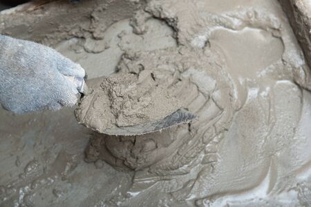 Plaster preparation. Man plastering wall. Worker makes renovation. Construction work, repair.の写真素材