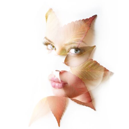 Double exposure portrait of beautiful young woman and fall leaves isolated on white background....
