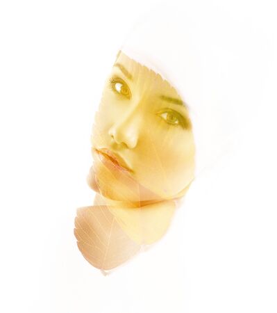 Double exposure portrait of beautiful young woman and fall leaves isolated on white background. Autumnal seasonal concept design elementの写真素材