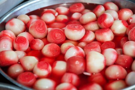 Salting onion sold on outdoor spanish market.
