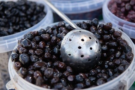 Salting olives sold on outdoor spanish market.の写真素材