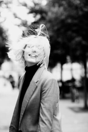 Outdoor urban female portrait, black and white. Fashion model. Young woman posing in Milan streets against. Happy jumping girl, motion blur effectの写真素材
