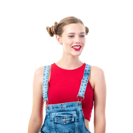 Pretty funny emotional teen girl, portrait over white background. Beautiful woman wearing red top and blue jeans. Young charming lady with blue eyes and blond hairの写真素材