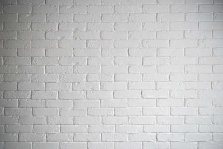 Modern white brick wall texture with light and shadow for backgroundの写真素材