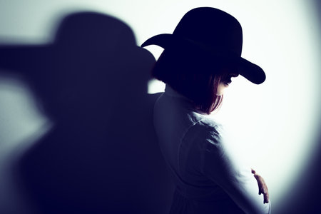 Mysterious fashion young woman in black hat and white shirt, copy space where can the advertising...