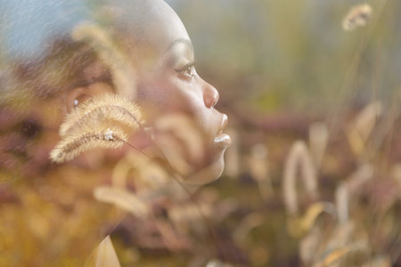 Gorgeous young african american woman with dry summer plant double exposure.