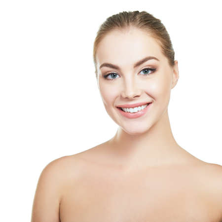 Young attractive woman posing at studio and happy smiling over white background. Beautiful girl with perfect smile.の写真素材