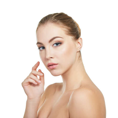 Young attractive woman with perfect make-up posing at studio over white background, beauty female portrait.の写真素材