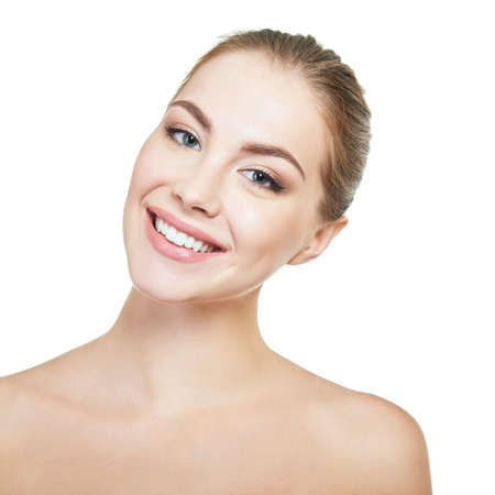 Young attractive woman posing at studio and happy smiling over white background. Beautiful girl with perfect smile.の写真素材