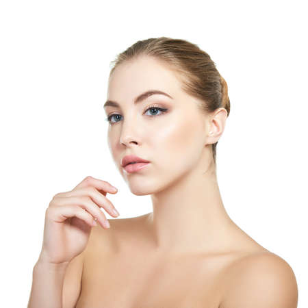 Young attractive woman with perfect make-up posing at studio over white background, beauty female portrait.の写真素材