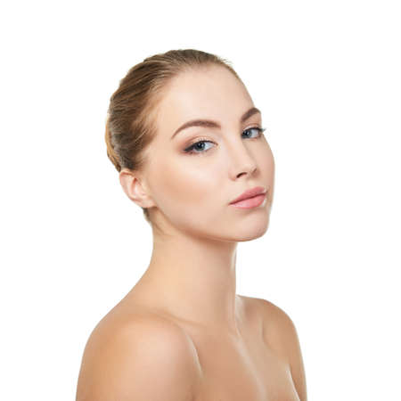 Young attractive woman with perfect make-up posing at studio over white background, beauty female portrait.の写真素材