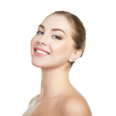 Young attractive woman posing at studio and happy smiling over white background. Beautiful girl with perfect smile.の写真素材