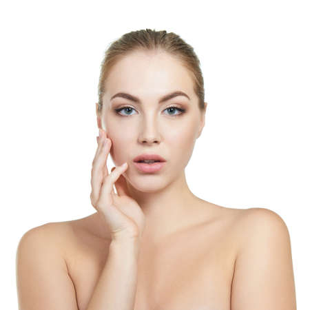 Young attractive woman with perfect make-up posing at studio over white background, beauty female portrait.の写真素材