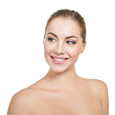 Young attractive woman posing at studio and happy smiling over white background. Beautiful girl with perfect smile.の写真素材