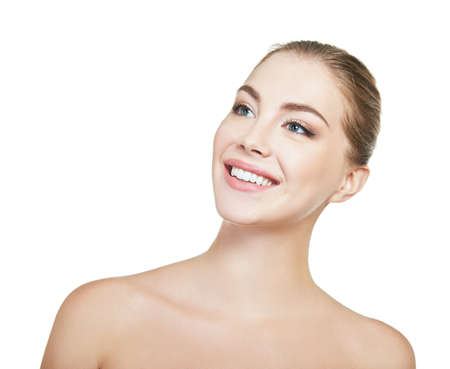 Young attractive woman posing at studio and happy smiling over white background. Beautiful girl with perfect smile.の写真素材