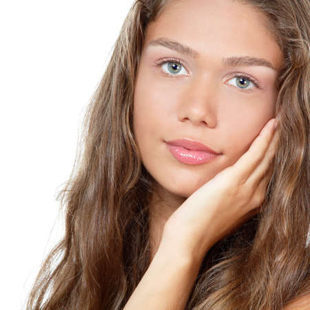 Portrait of a beautiful young woman with clean skin and long curly fair hair, beauty treatment, cosmetology and anti-aging themeの写真素材