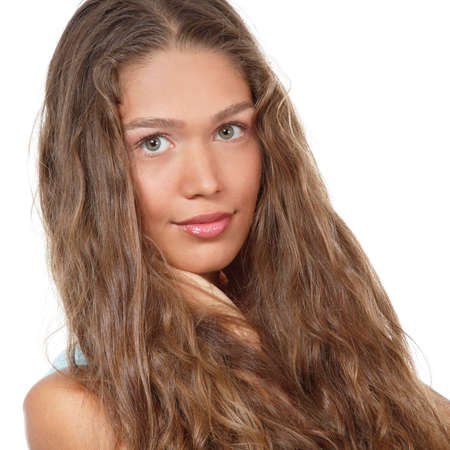 Portrait of a beautiful young woman with clean skin and long curly fair hair, beauty treatment, cosmetology and anti-aging themeの写真素材