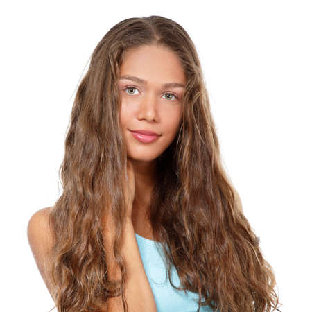 Portrait of a beautiful young woman with clean skin and long curly fair hair, beauty treatment, cosmetology and anti-aging themeの写真素材