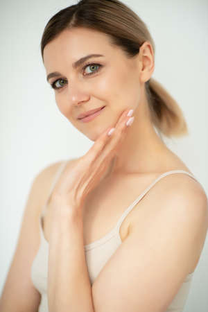 Beautiful calm middle aged woman, natural light. Anti-aging and beauty treatment.の写真素材