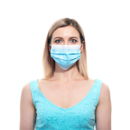 Attractive middle aged woman wearing protective medical mask during quarantine COVID-19, over white background.の写真素材