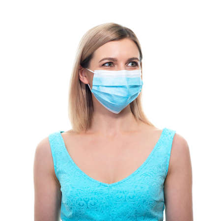 Attractive middle aged woman wearing protective medical mask during quarantine COVID-19, over white background.の写真素材