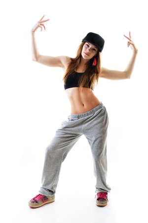 Young girl dancing hip-hip in streetwear at studio on a white backgroundの写真素材