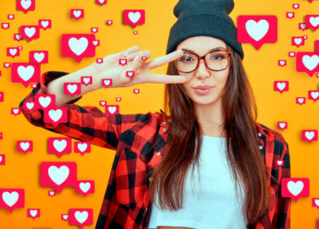 Young cool woman blogger over orange background with a lots of Likes from social networks. Success,...