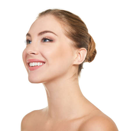 Young attractive woman posing at studio and happy smiling over white background. Beautiful girl with perfect smile.の写真素材