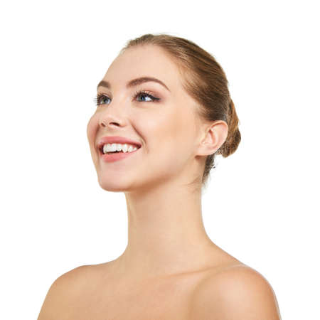 Young attractive woman posing at studio and happy smiling over white background. Beautiful girl with perfect smile.の写真素材