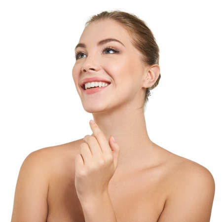 Young attractive woman posing at studio and happy smiling over white background. Beautiful girl with perfect smile.の写真素材