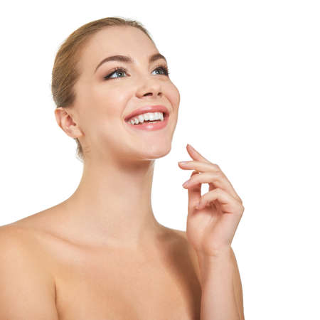 Young attractive woman posing at studio and happy smiling over white background. Beautiful girl with perfect smile.の写真素材