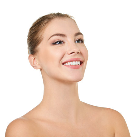 Young attractive woman posing at studio and happy smiling over white background. Beautiful girl with perfect smile.の写真素材
