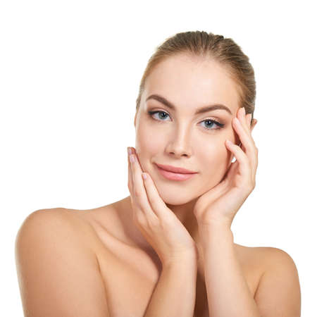 Young attractive woman with perfect make-up posing at studio over white background, beauty female portrait.の写真素材