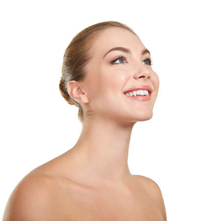 Young attractive woman posing at studio and happy smiling over white background. Beautiful girl with perfect smile.の写真素材