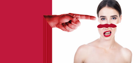 Beautiful young woman holding bullet in her teeth and shifted upper part of the head with index finger of the big male hand. Concept of outside influence and pressure on personality. Ð¡ontemporary art collage, trendy urban magazine style.の写真素材