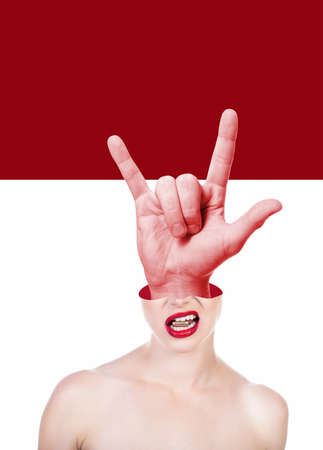 Beautiful young woman holding bullet in her teeth and shifted upper part of the head and big male hand with horns sign inside. Ð¡ontemporary art collage, trendy urban magazine style.の写真素材