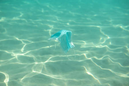 Ocean pollution. Consequences of overuse of surgical masks and improper waste disposal during the virus pandemic.の写真素材